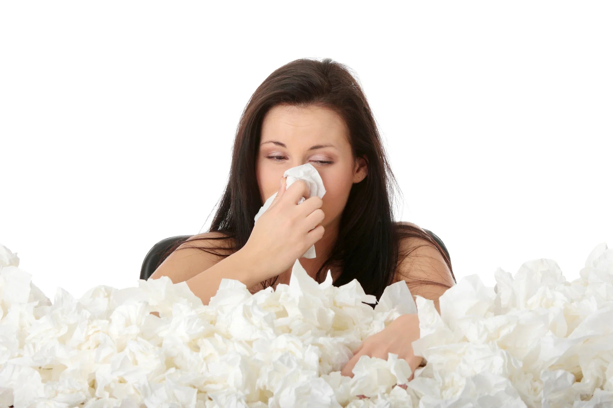 Woman surrounded by tissues wiping nose, allergy symptoms, hypoallergenic apparel concept