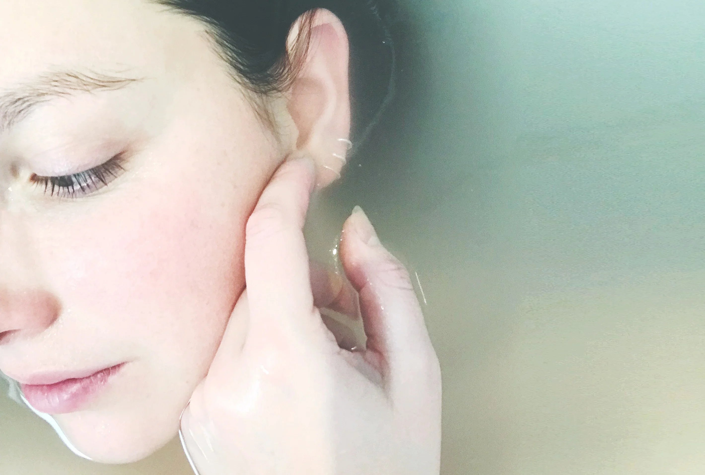 Close-up of woman with sensitive skin relaxing in water, highlighting natural skincare