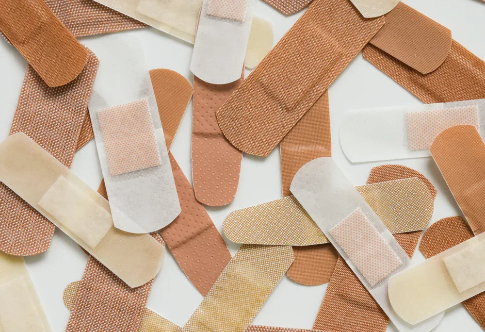 Assorted hypoallergenic adhesive bandages on white background for sensitive skin