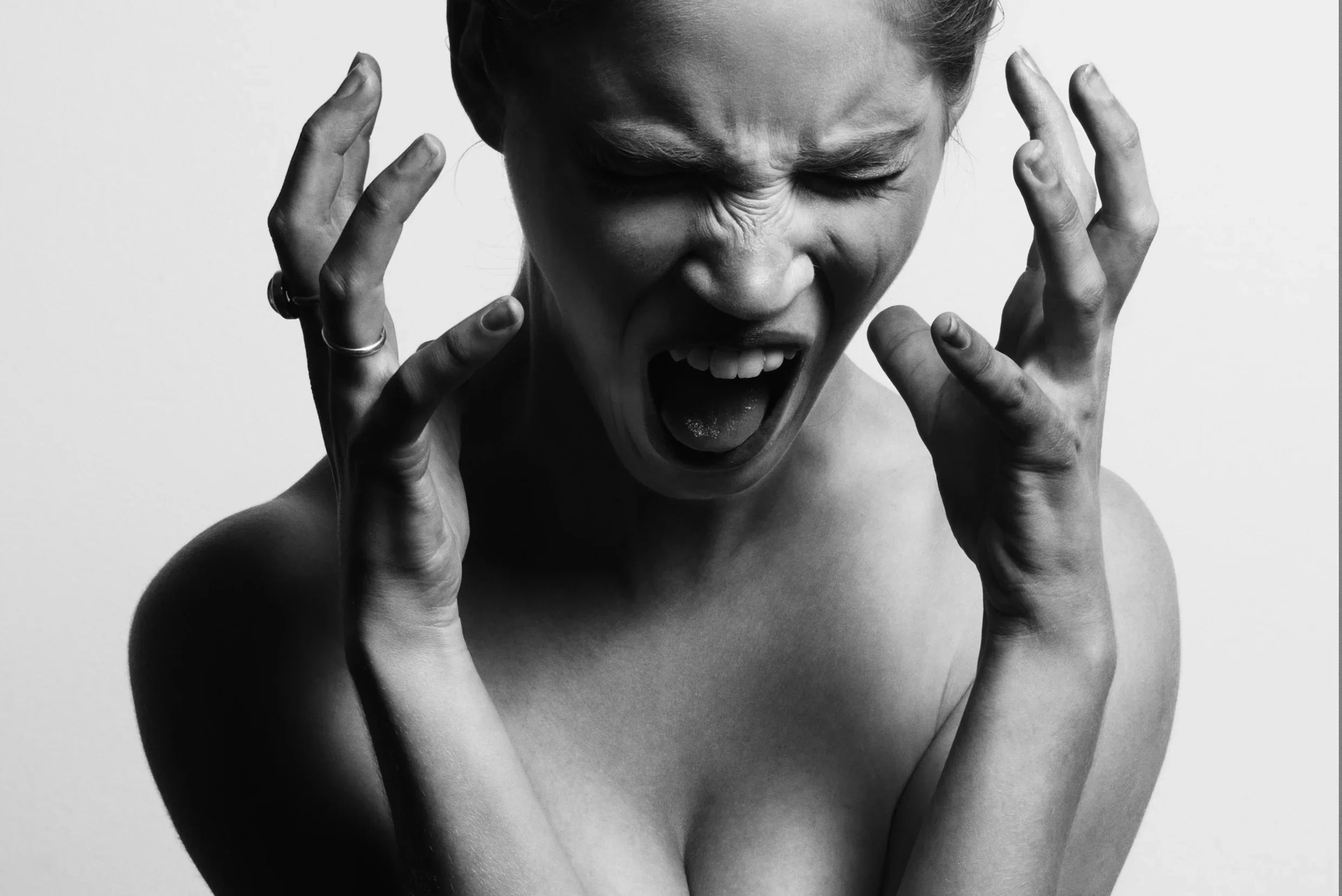 Black and white photo of a woman expressing stress, relevant to allergy-free apparel comfort