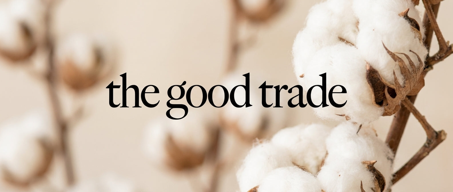 Close-up of organic cotton bolls with 'the good trade' text overlay.