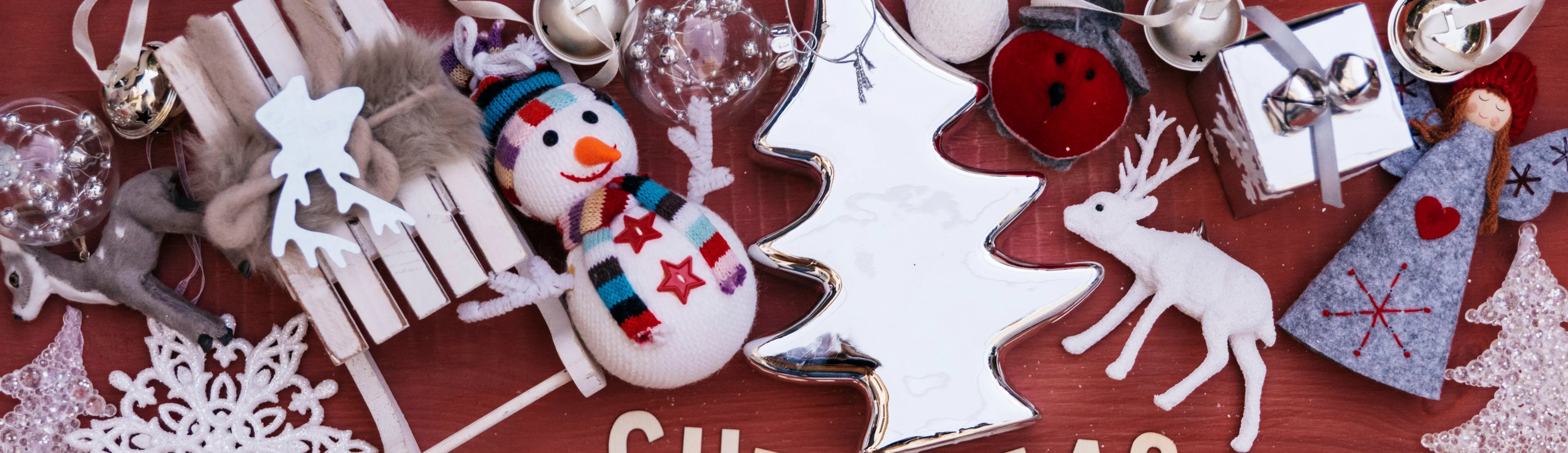Festive Christmas decorations with snowman, silver tree, reindeer, and holiday ornaments