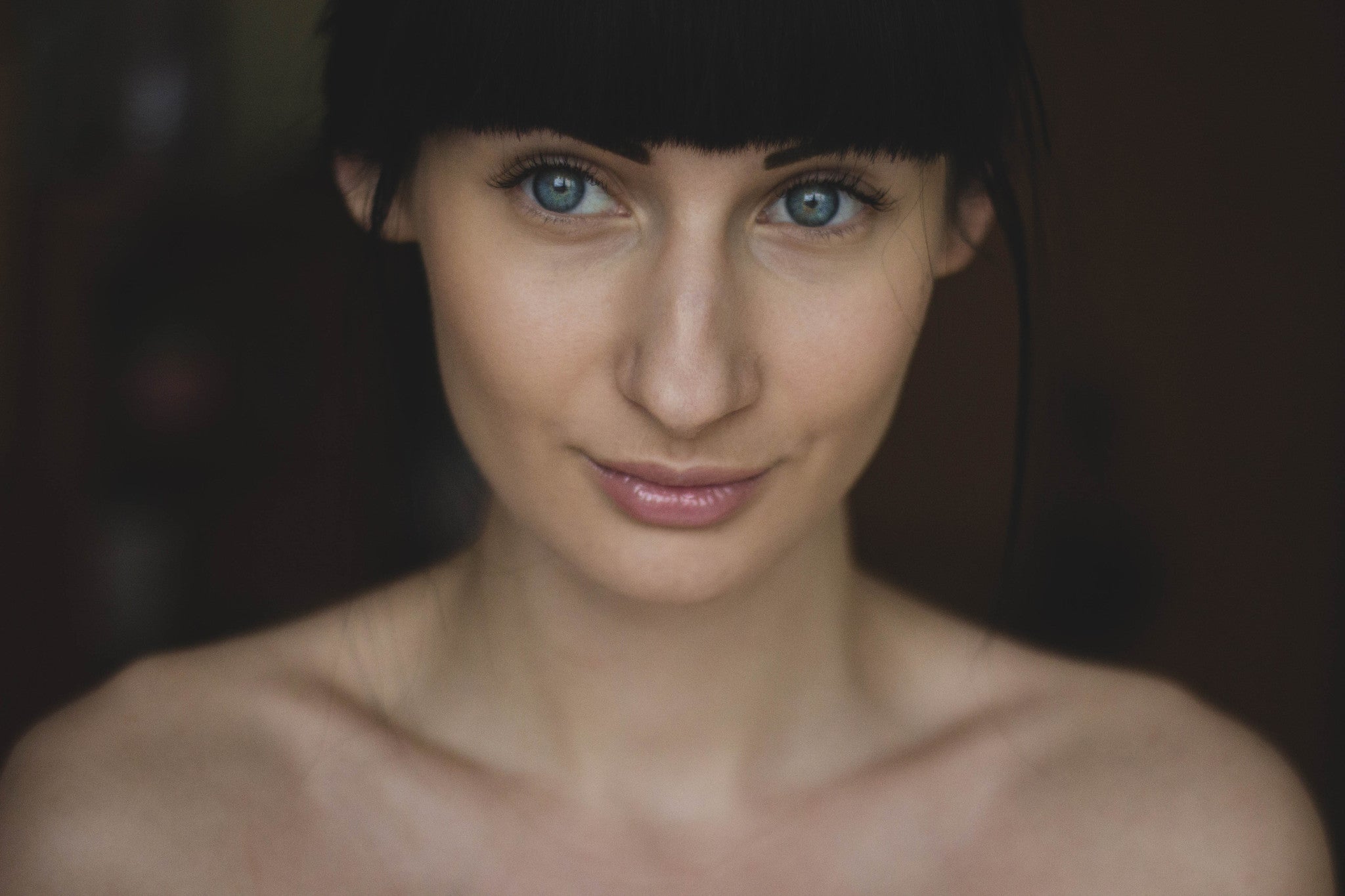 Close-up of woman with clear skin and blue eyes, suitable for sensitive skin apparel
