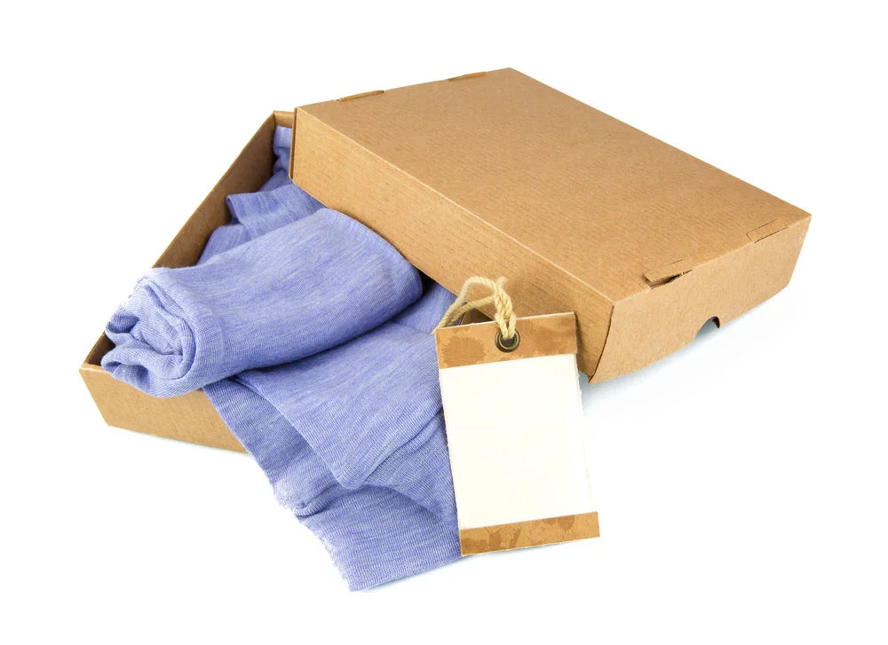Light purple hypoallergenic cotton clothing in a kraft box with blank tag, Cottonique apparel