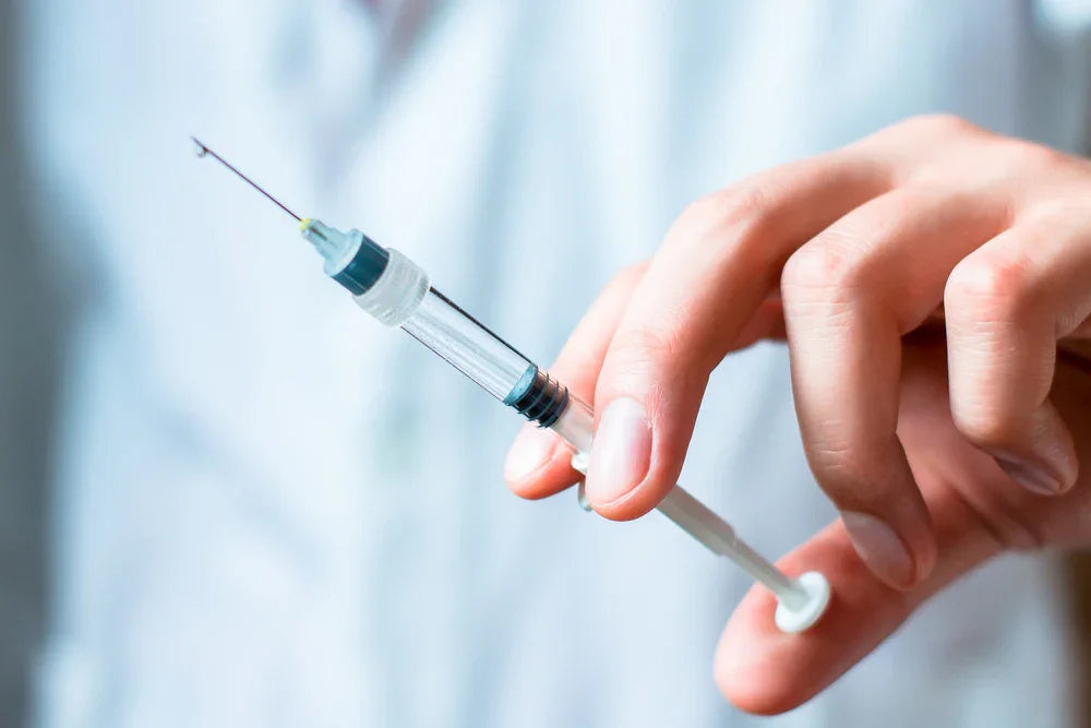 Close-up of hand holding medical syringe, healthcare and allergy treatment concept