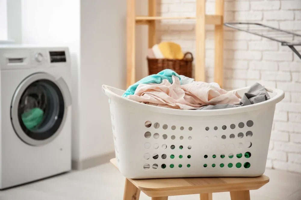 Laundry basket with soft clothes in a washing room, ideal for sensitive skin care.