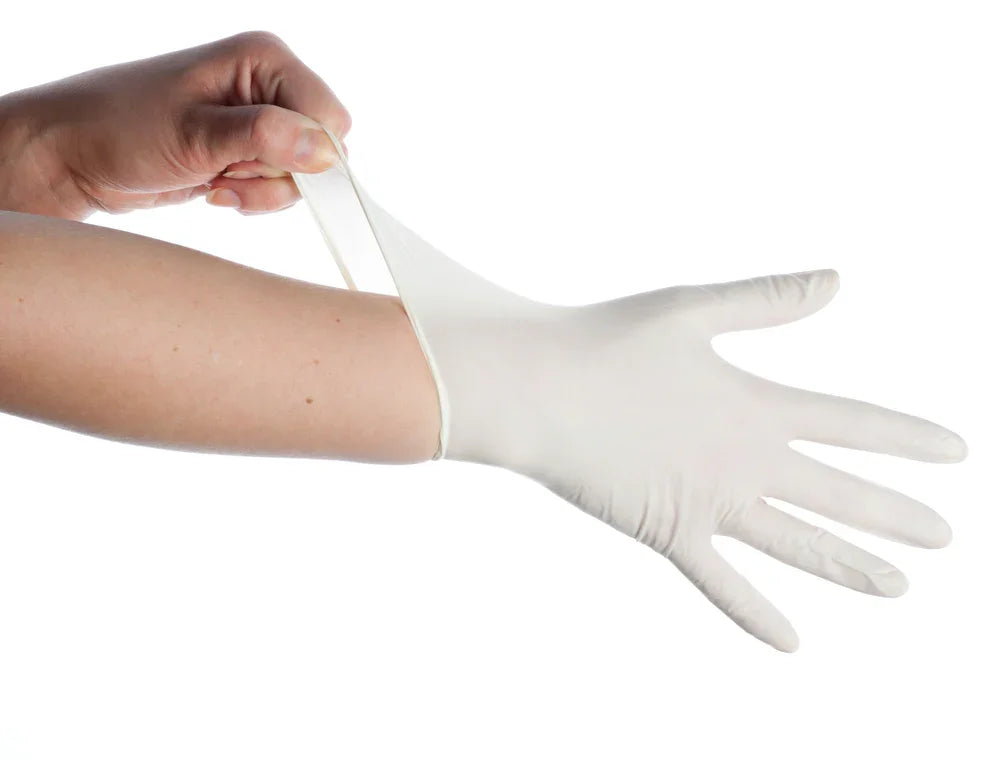 Hand putting on a white hypoallergenic glove, allergy-free apparel focus, plain background
