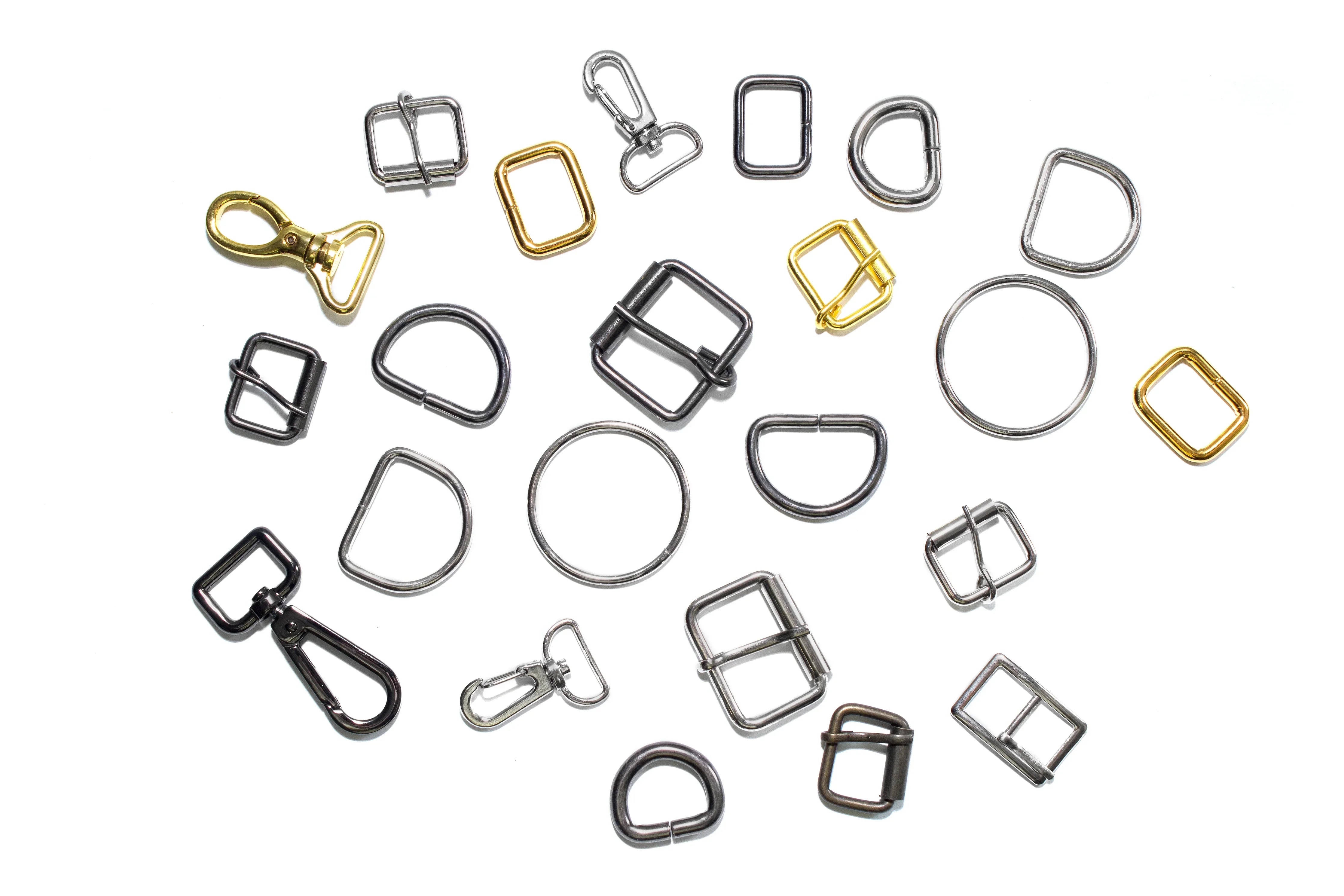 Assorted metal buckles, D-rings, and clasps for garment making on white background