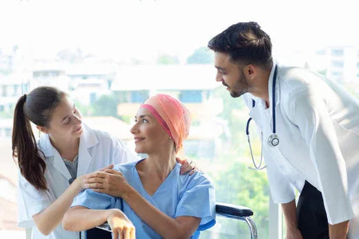 Smiling female patient in headscarf with supportive doctors, healthcare and recovery concept