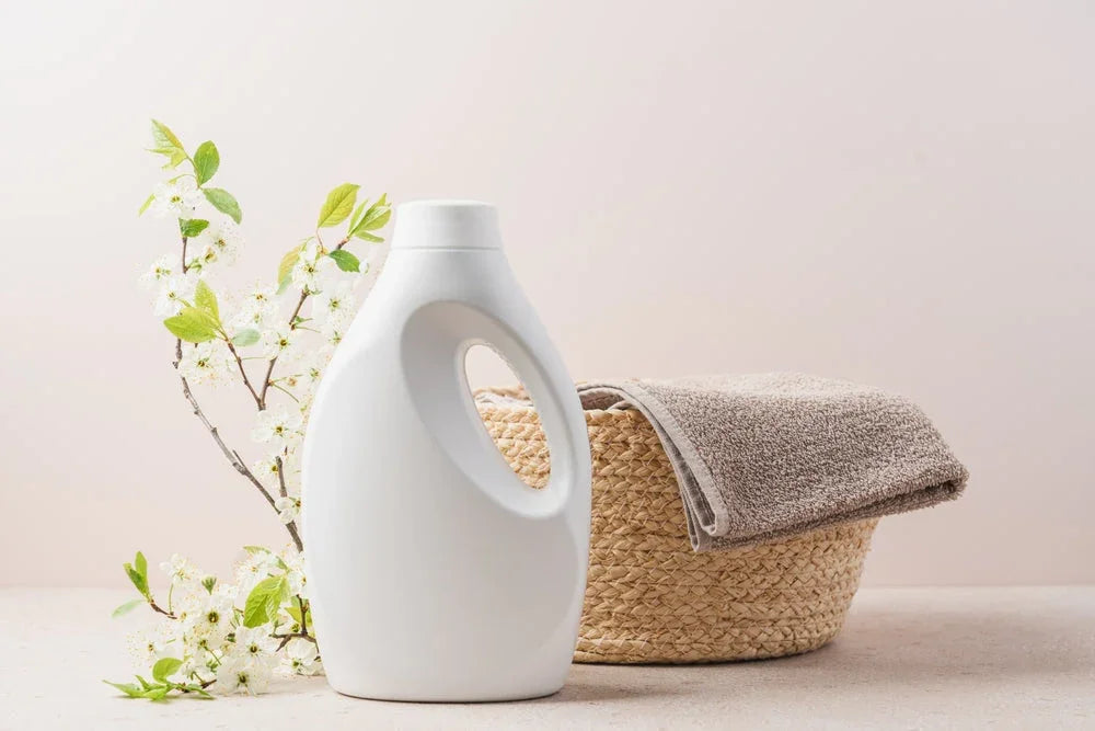 Hypoallergenic laundry detergent bottle with towel in basket and flowers, gentle for sensitive skin