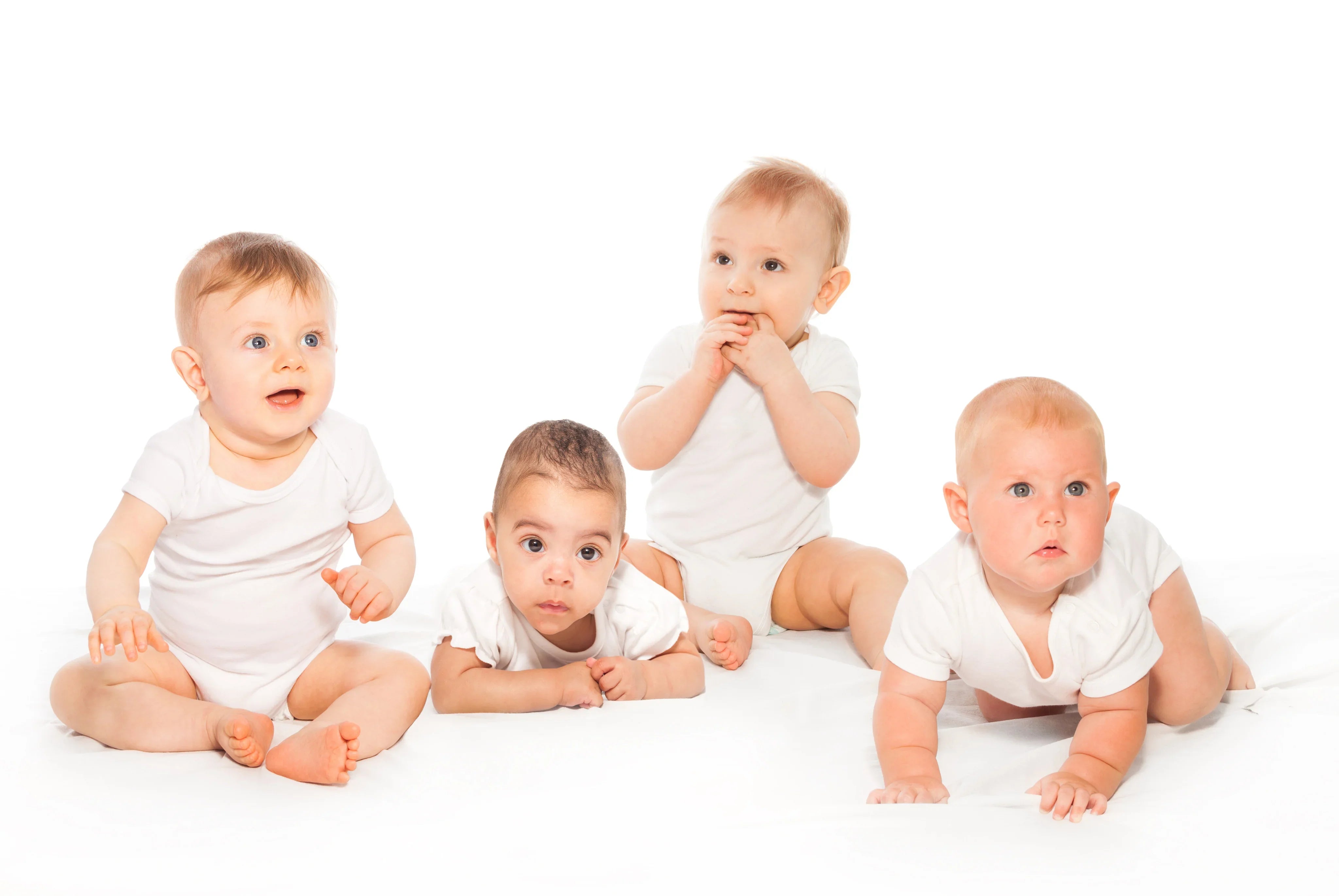 Four babies in white organic cotton onesies on a white background