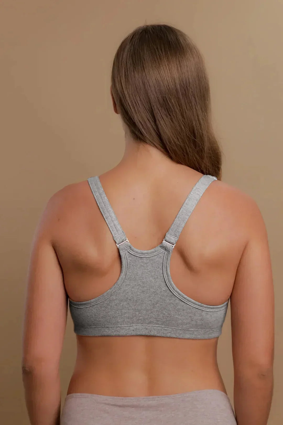 Back view of woman wearing a gray organic cotton racerback bra for sensitive skin