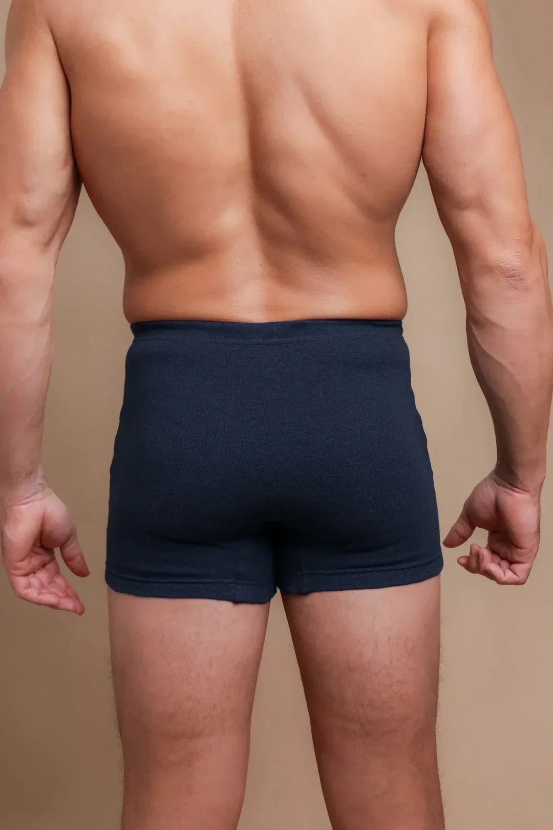 Back view of man wearing navy high-waist organic cotton boxer briefs for sensitive skin